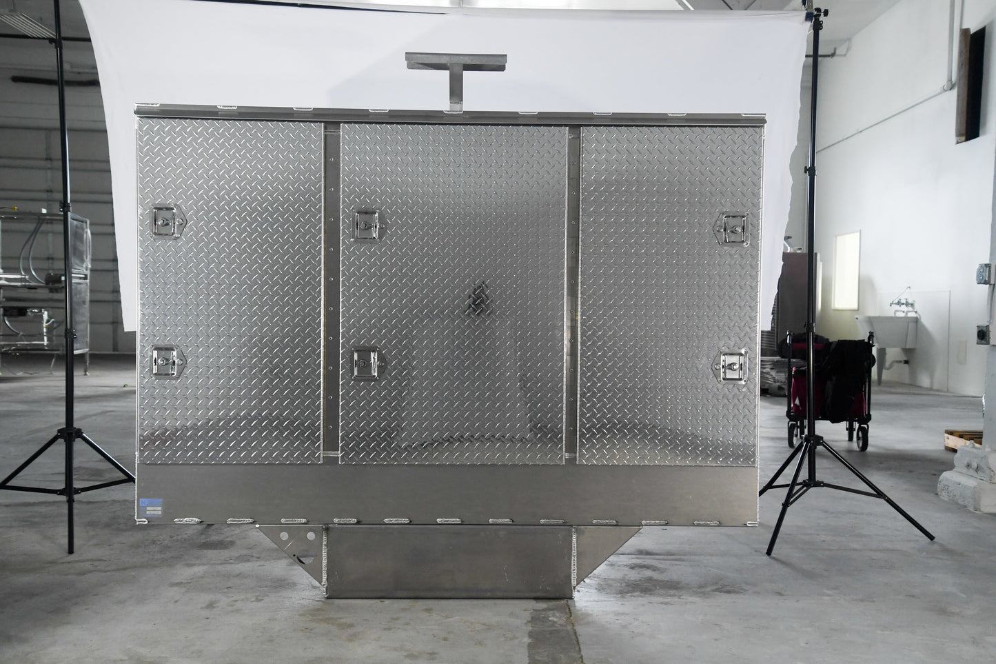 Large metallic storage unit in a warehouse setting